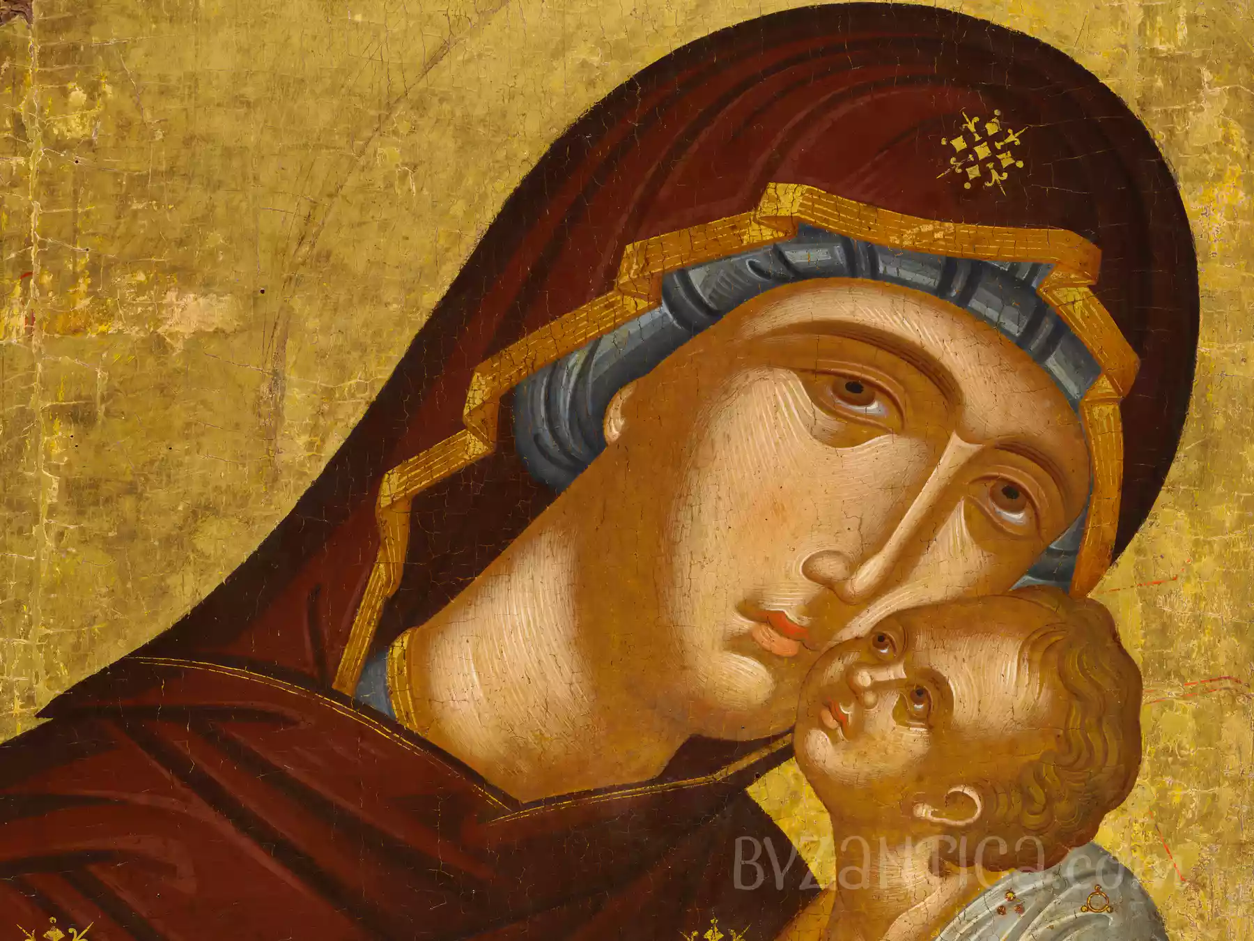 Face detail from Virgin Eleousa Byzantine icon depicting intimate maternal moment