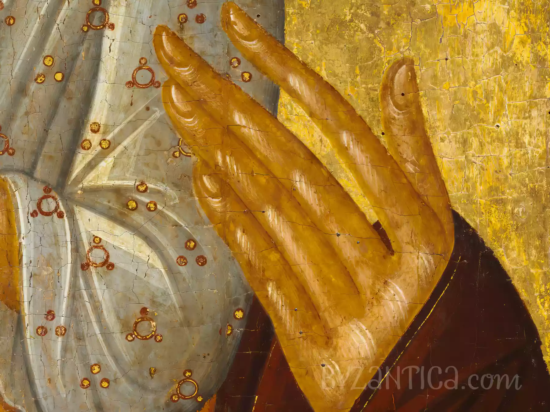 Detail of Virgin Eleousa byzantine icon showing mother's graceful hands holding the Christ child