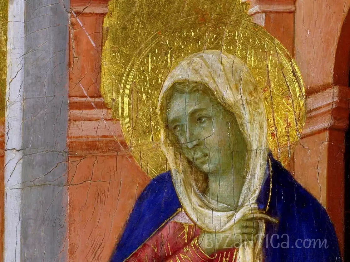 A detail of Duccio's Annunciation tempera painting showing Mary's face and gilded halo